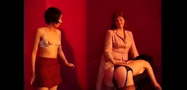  Mature teacher with big forms punishes two pretty schoolgirls and hits them with a pointer